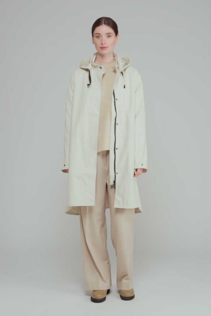 Load video: Rain Jacket in Milk Creme by Ilse Jacobsen